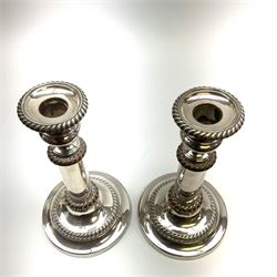 A pair of silver plated telescopic candlesticks, with gadrooned detail and spreading circular feet, not extended H21.5cm extended H28cm.