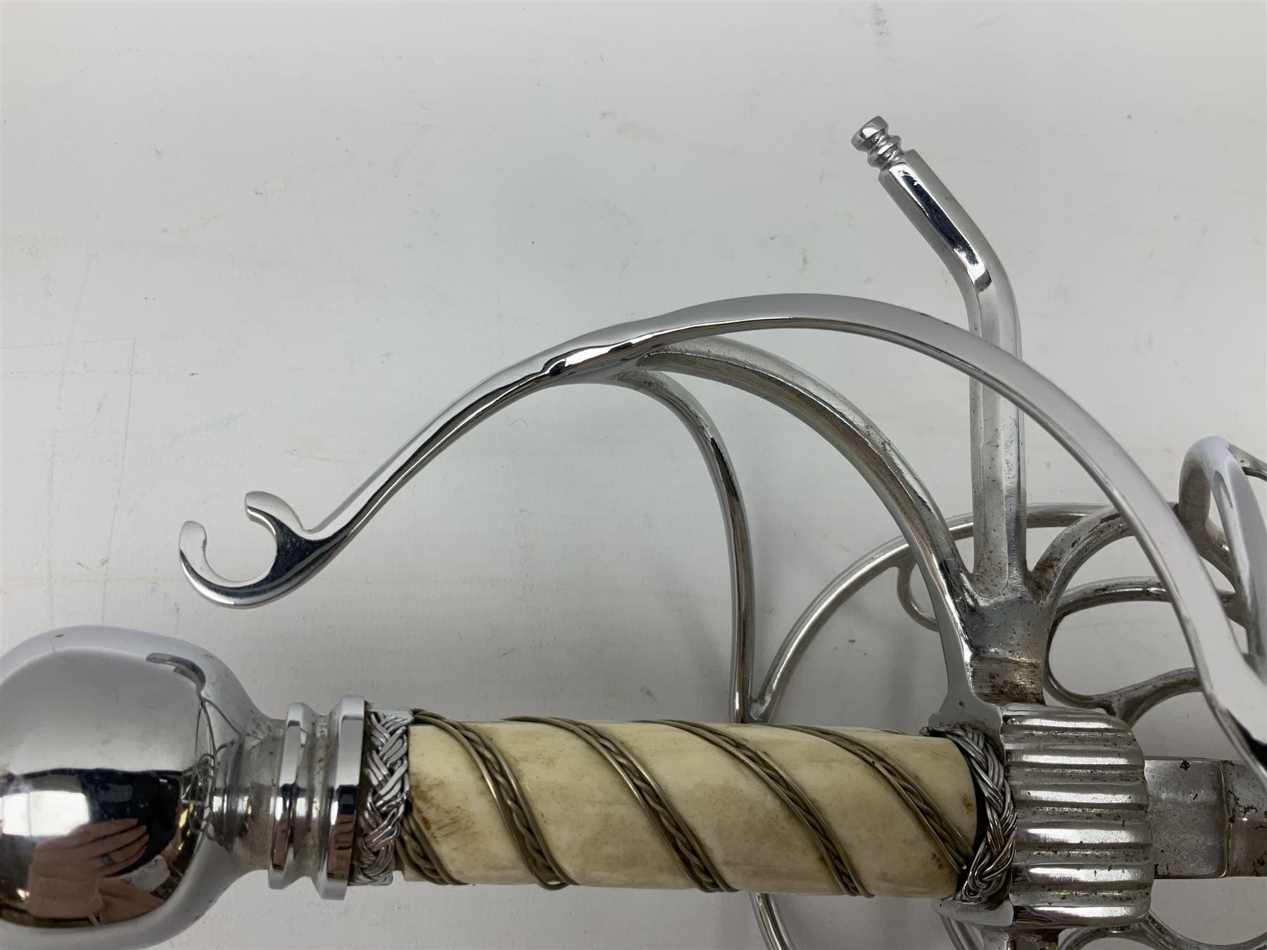 Replica knight's longsword, the 91.5cm double-edged steel blade with basket hilt and wire-bound bone grip with spherical pommel, in leather scabbard L112cm overall