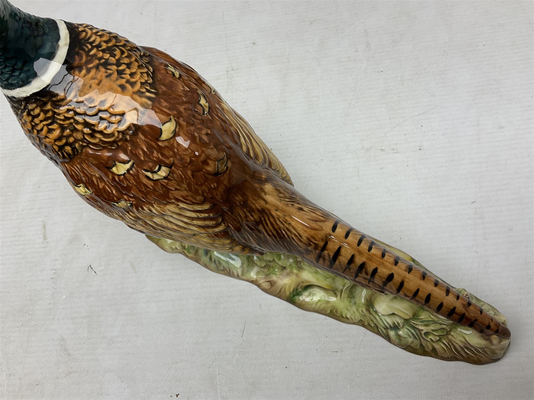 Three Beswick figures of birds, comprising pheasant no 1225, magpie no 2305 and woodpecker 1218, all with impressed marks beneath, tallest H22cm