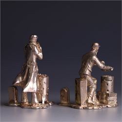 Two silver place card holders from the 'Cries of London' series, each depicting traditional London street traders, hallmarked Thomas Charles Jarvis, London 2000, tallest H5cm