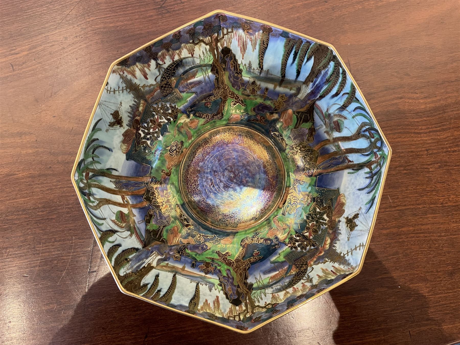 Early 20th century Wedgwood Fairland lustre bowl, circa 1920, of octagonal form, designed by Daisy Makeig-Jones, the exterior decorated in the Castle on the Road pattern, the interior decorated in the Fairy in a Cage pattern, pattern no Z5125, with printed marks beneath, H11cm D22.5cm
