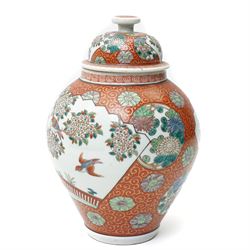 Japanese vase and cover decorated with panels of exotic birds in a fenced garden setting o...