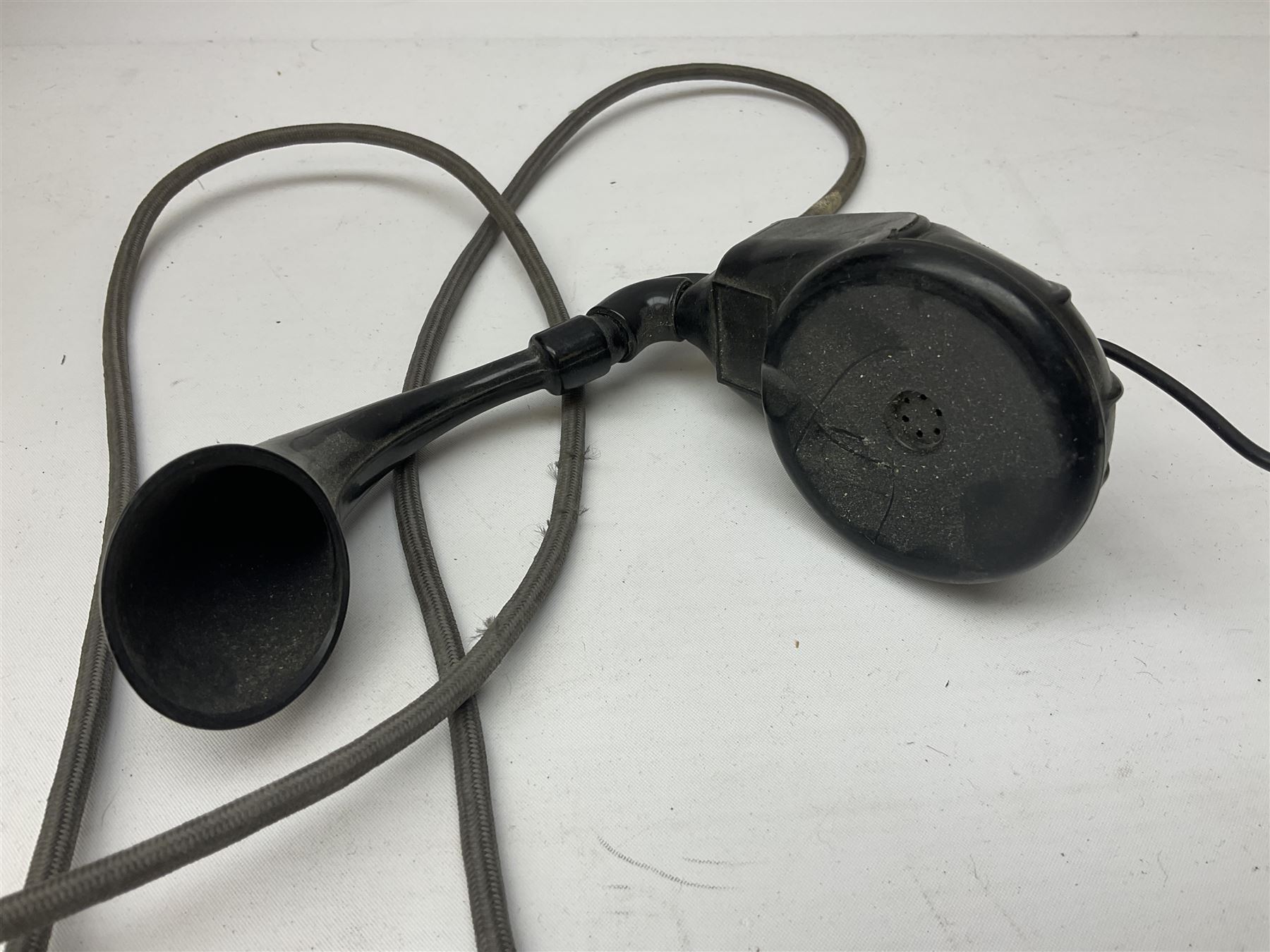 Early-mid 20th century internal telephone system, comprising exchange box with attached TMC rotary telephone and dictograph with Bakelite handset and support upon stained wood case, and 1960s black Bakelite telephone model 312L with G.P.O sticker beneath, largest H30.5cm W36.5cm D30cm