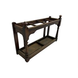Edwardian oak hallway stick and umbrella stand, four divisions on turned supports, with metal tray liners and various sticks