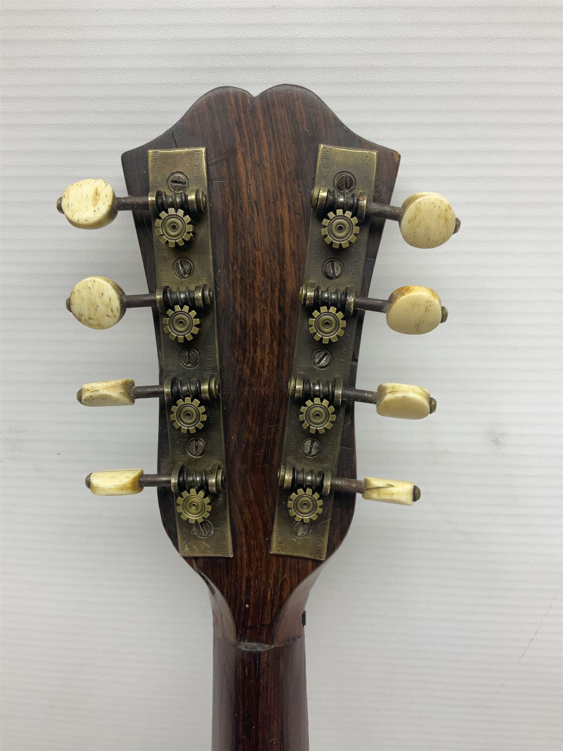 Late 19th century Italian lute back mandolin with segmented bowl back, bears label Gennaro Maglioni Napoli L61cm; in ebonised wooden case; together with another similar damaged Italian lute back mandolin for restoration or spares (2)