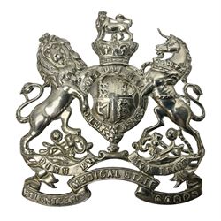 Victorian Volunteer Medical Staff Corps white metal helmet plate in the form of Victorian crowned Royal Arms with three part lower scroll for “VOLUNTEER MEDICAL STAFF CORPS”; three lug fittings to the reverse L8.5cm