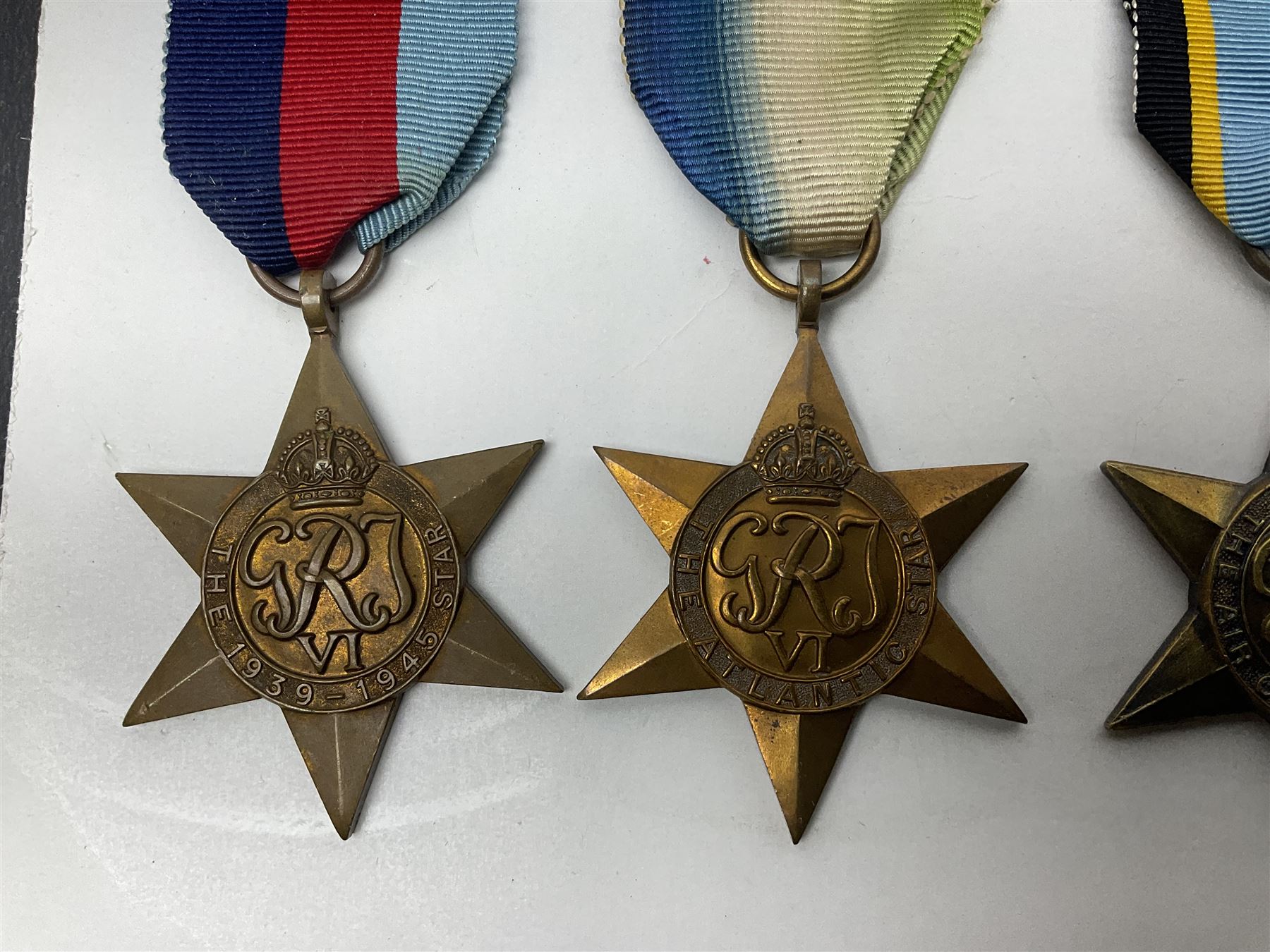 Representative display of WWII Campaign stars comprising 1939-1945 Star, Atlantic Star, Air-Crew Europe Star, Africa Star and Pacific Star; together with the corresponding group of miniatures; all with ribbons