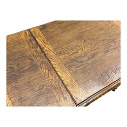 Edwardian oak metamorphic 'Britisher Writing Table', rectangular hinged top revealing correspondence compartments and hinged writing surface with underside storage, flanked by twin hinged compartments with dividers, on turned supports