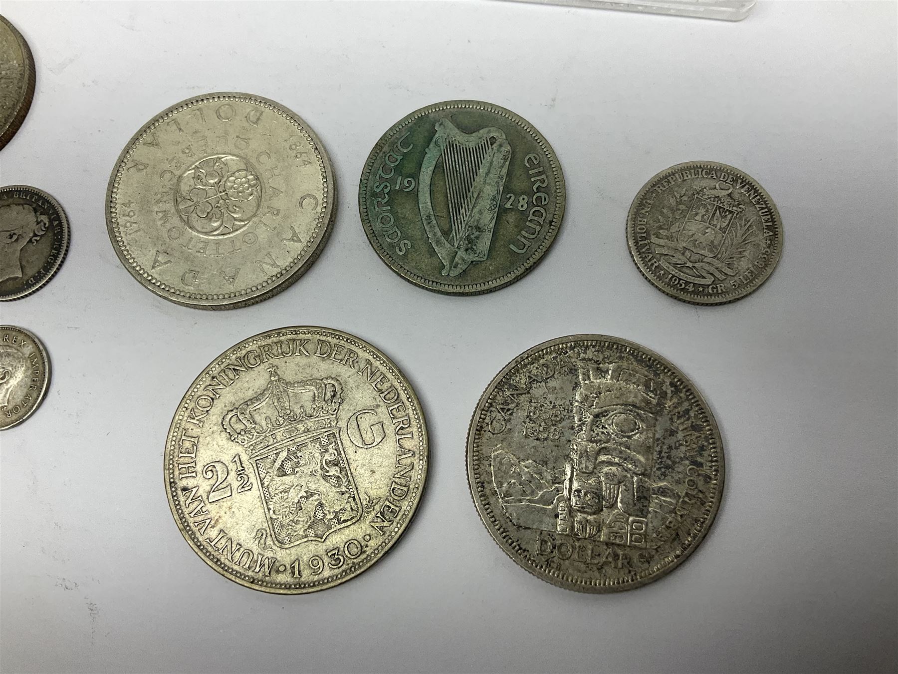 South Africa 1897 one shilling, 1967 one rand, Ireland 1928 two shillings and sixpence, Netherlands 1930 two and a half gulden, two Queen Elizabeth II Canada one dollar coins dated 1958 and 1964, 1967 six coin set in plastic holder etc