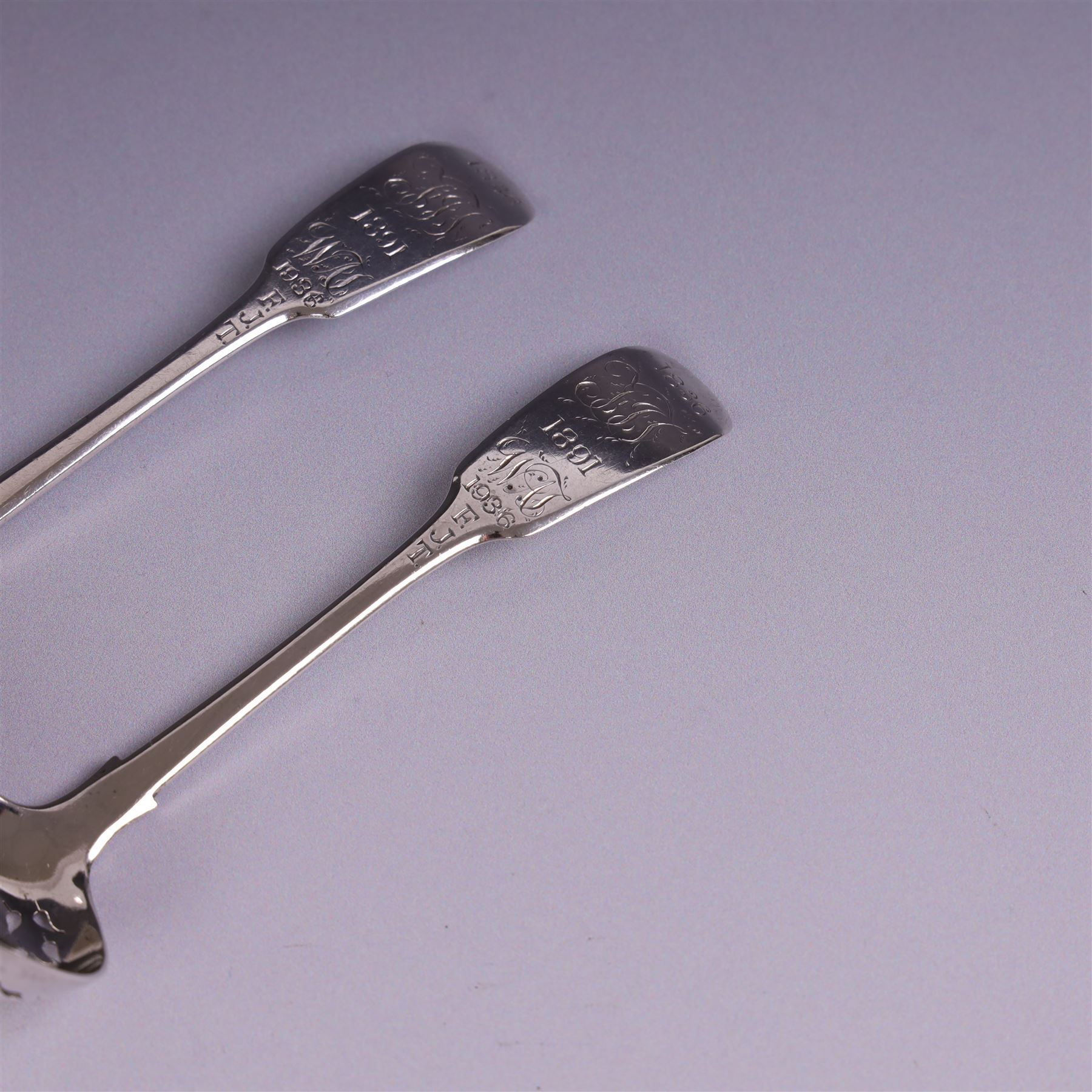 Pair of William IV silver Fiddle pattern spoons, comprising ladle and sifting spoon, each with presentation engravings to terminal, hallmarked William Rawlings Sobey, Exeter 1836