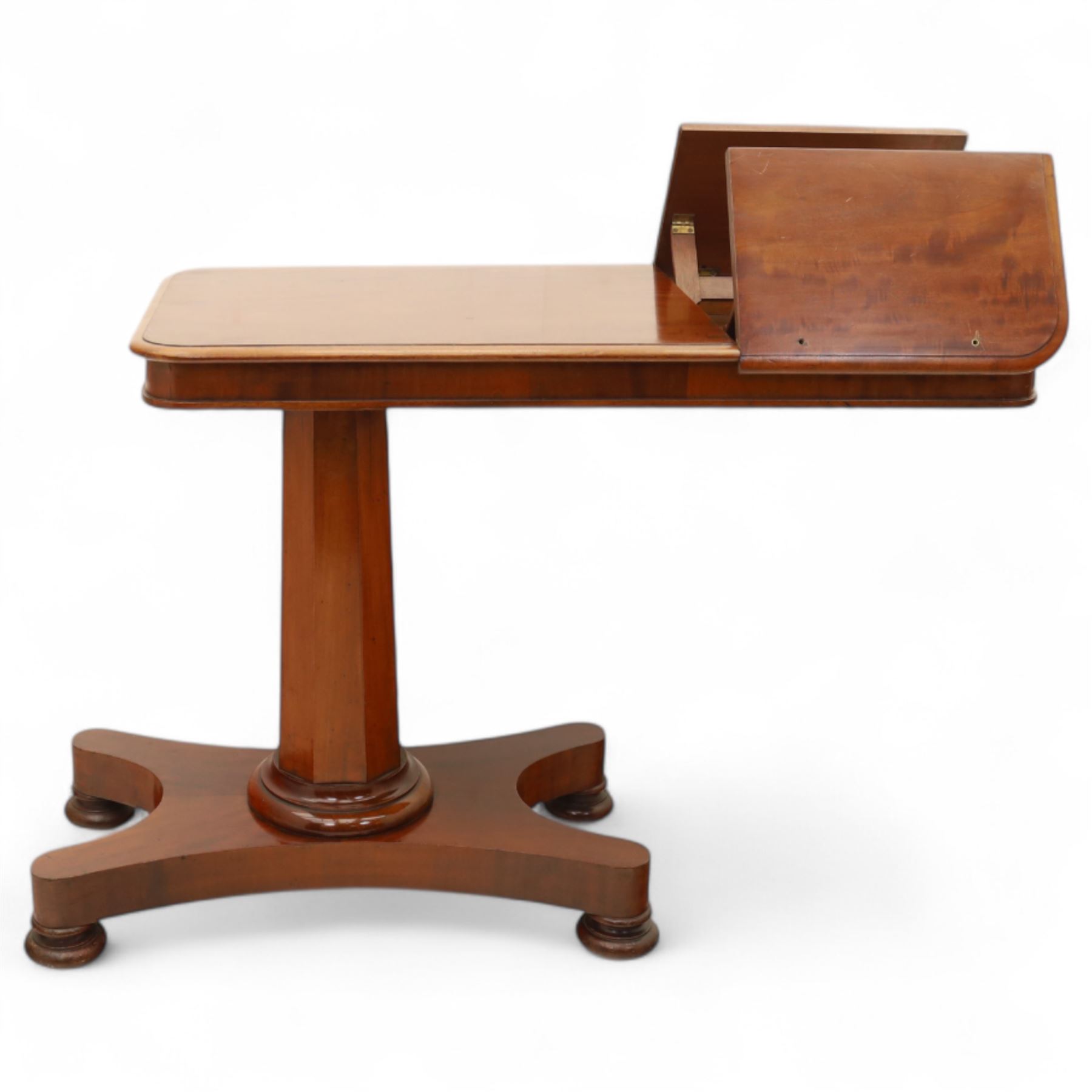 William IV mahogany reading table, the rectangular top with rounded corners and moulded edge, one end fitted with two hinged adjustable reading slops with two rests, the sliding top with a sprung stay mechanism, supported on a single tapered faceted column  with turned collar on a quatreform base with compressed bun feet