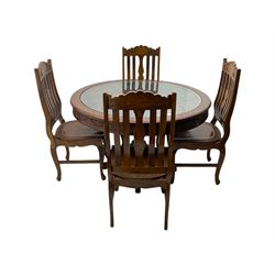 Pakistan carved hardwood brass inlaid circular dining table, and four rail back chairs with saddle seats