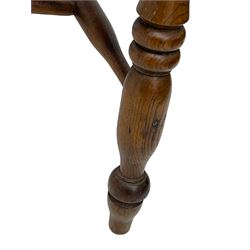 Early 19th century elm farmhouse armchair, the shaped eared cresting rail over tall spindle back, dished seat on turned supports united by H stretchers