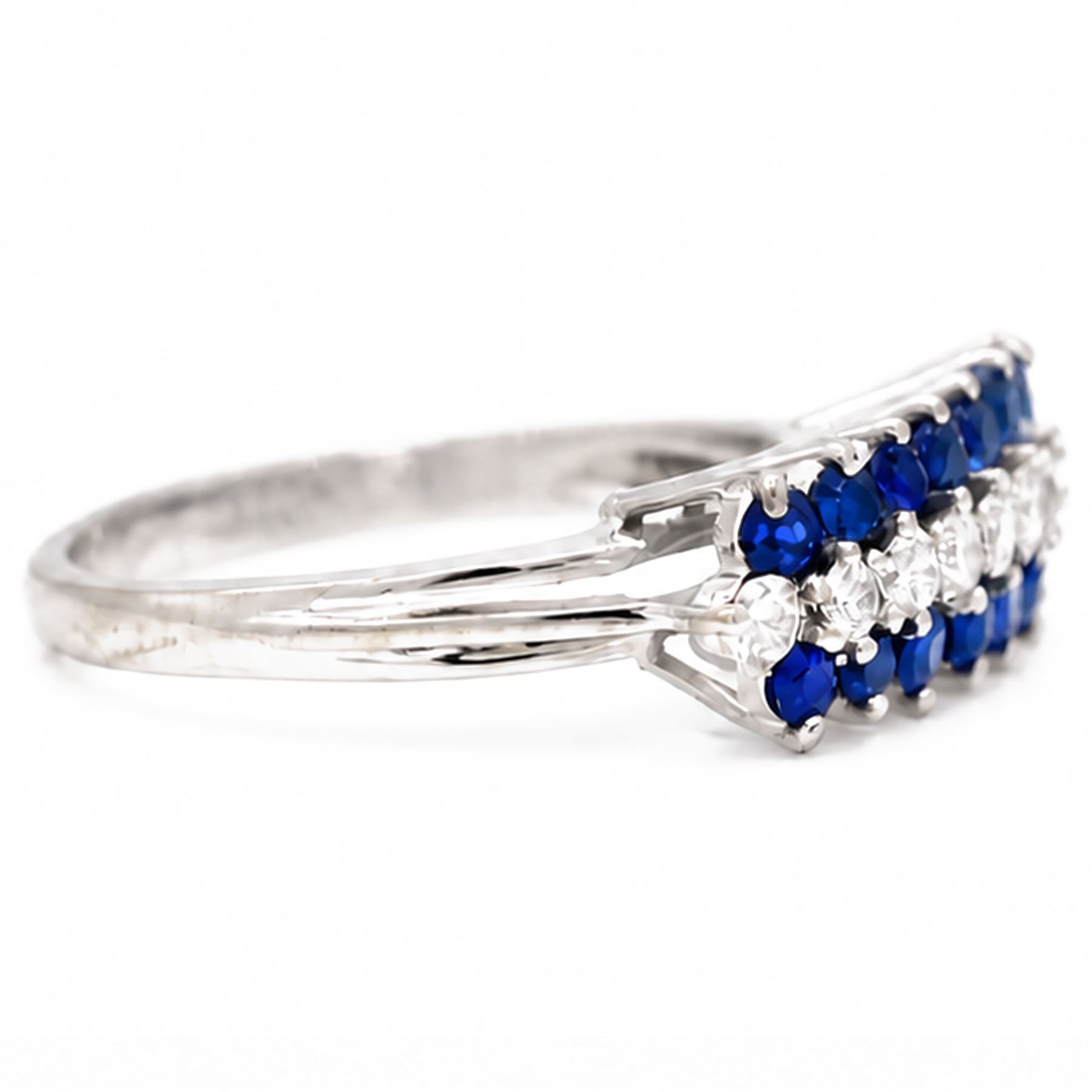 White gold diamond and sapphire three row ring, eight round brilliant cut diamonds, set between two rows of round cut sapphires, stamped 18ct, total diamond weight approx 0.30 carat