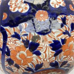 Pair of large 19th century Japanese Imari porcelain bottle vases, painted with shaped reserves of peonies, chrysanthemums and prunus blossom, each H46cm