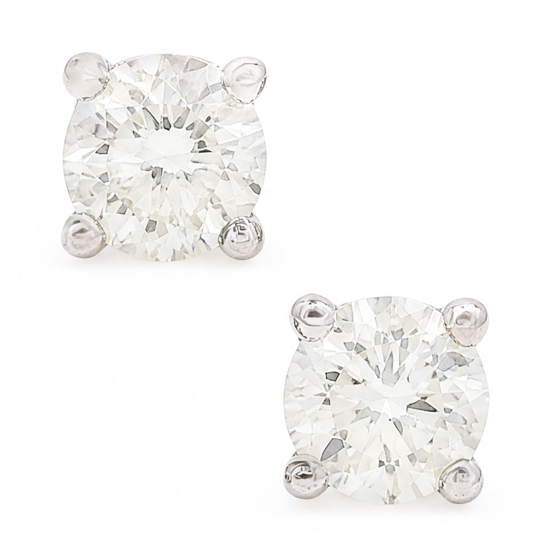 Pair of 18ct white gold diamond stud earrings, each stud set with a round brilliant cut diamond, stamped, total diamond weight approx 0.95 carat