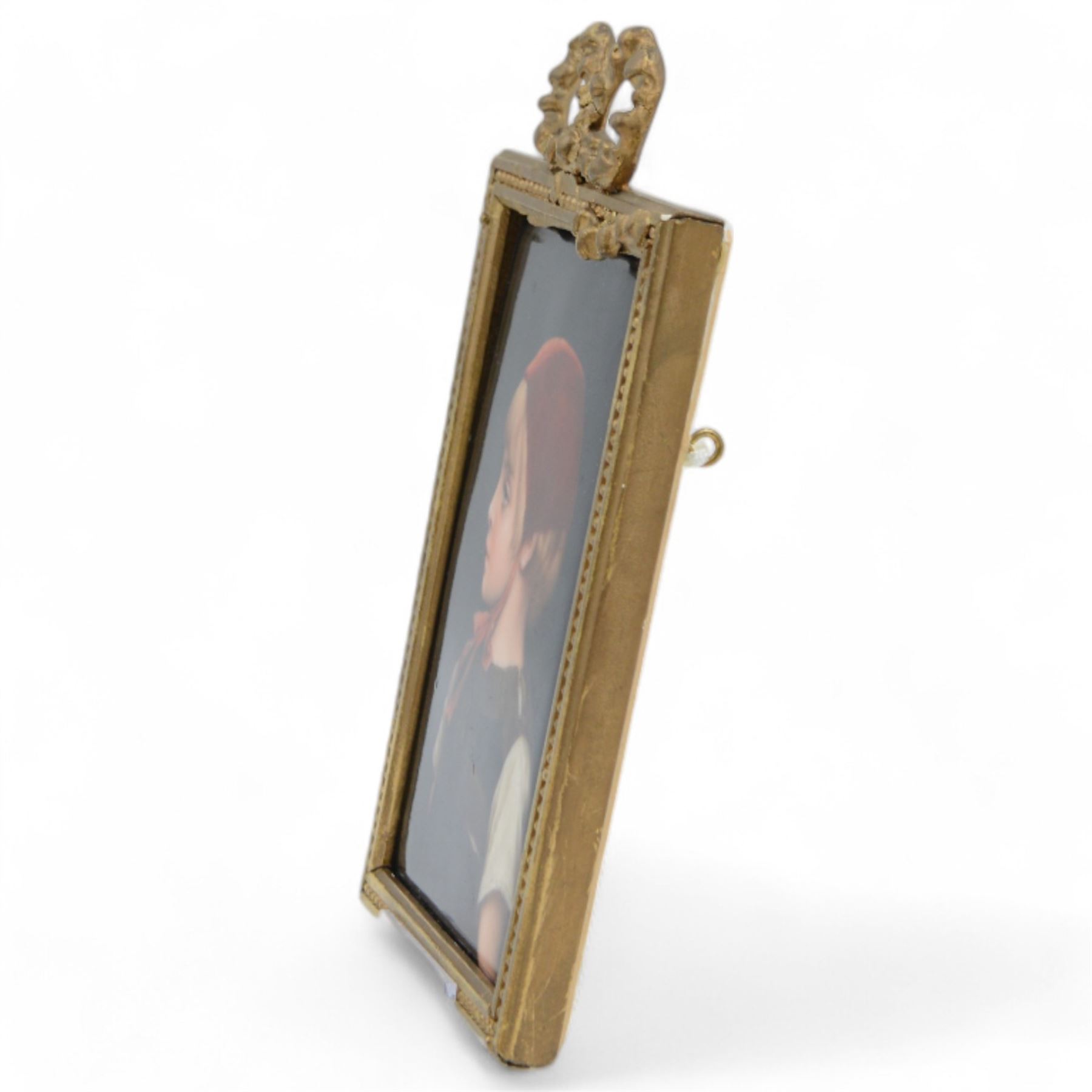 Late 19th/early 20th century German hand painted porcelain plaque, depicting a young girl in a red bonnet, after a painting by Gabriel Schachinger, within a beaded gilt frame with bow surmount, bearing paper label for Kunstinstitut fur Porzellan-Malerei Merkel-Heine Wiesbaden verso, and further paper label indistinctly inscribed '286 [...] Schachinger', also impressed 107, not including bow 16cm x 11.5cm
