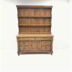  Victorian pine dresser, raised two tier plate rack above two frieze and four drawers, single cupboard, turned supports, W146cm, H197cm, D58cm  