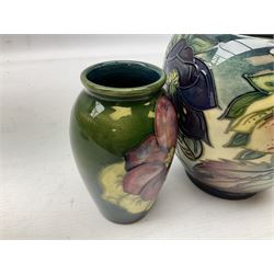 Moorcroft Hellebore pattern jar and cover, design by Nicola Slaney 1999, together with a Moorcroft clematis pattern vase, with paper label and printed beneath, H15.5cm