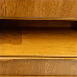 Sutcliffe of Todmorden - Mid 20th century teak highboard, ‘S-Form’ range, the upper section with glazed and panelled sliding doors above open shelving, over a base fitted with twin drawers and cupboards, all with moulded recessed handles, on shaped tapering supports, reflecting the sleek organic styling characteristic of 1960s British modern furniture design