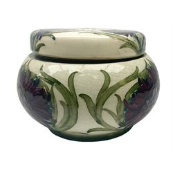 Moorcroft tobacco jar, circa 1913-1914, of squat bulbous form with screw threaded cover, decorated in the Revived Cornflower pattern, with impressed and painted marks beneath, H10cm.