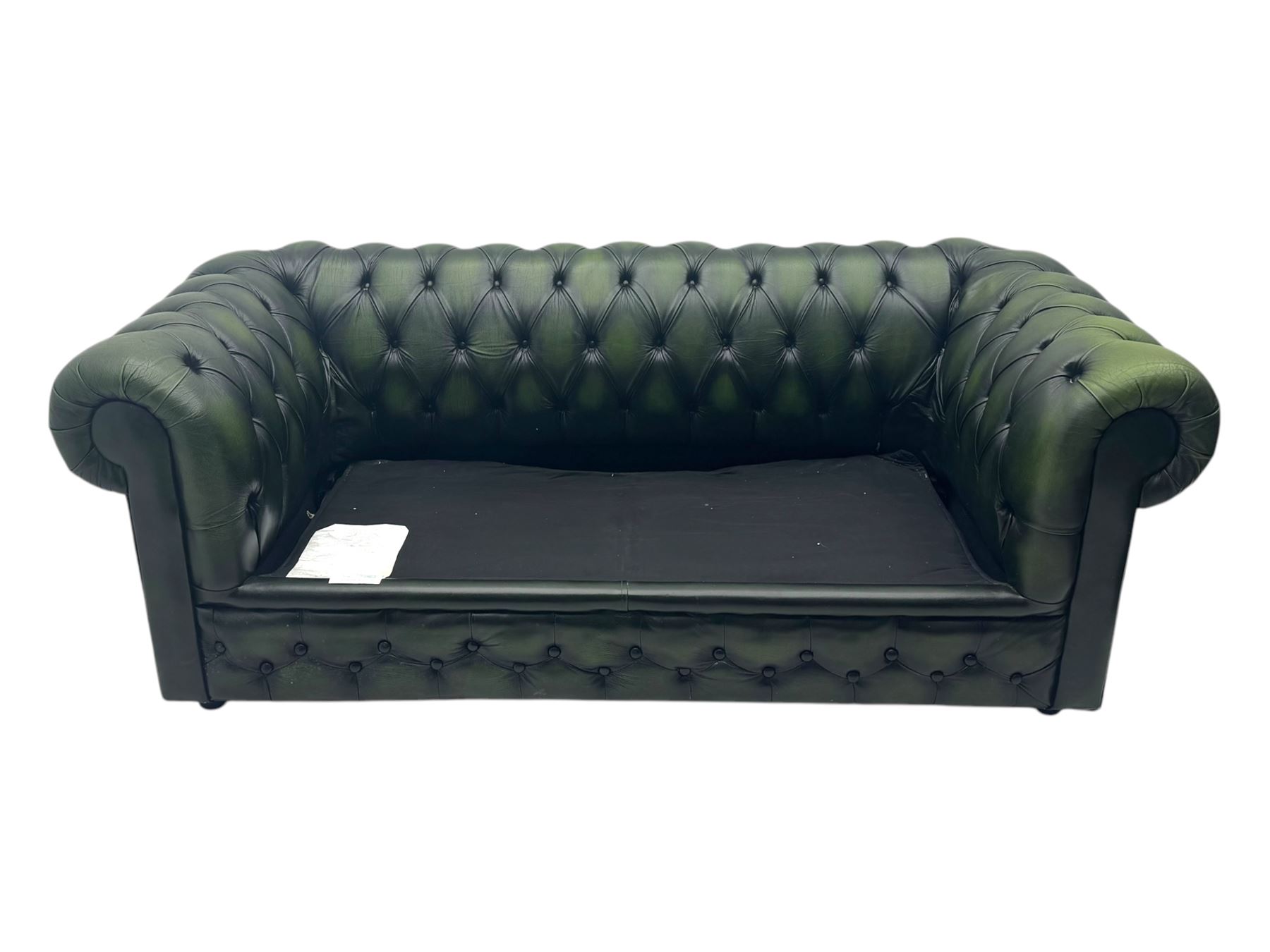 Two seat Chesterfield design sofa bed, upholstered in emerald green leather with deep-buttoned detailing, rolled arms, two loose seat cushions, and pull-out 
