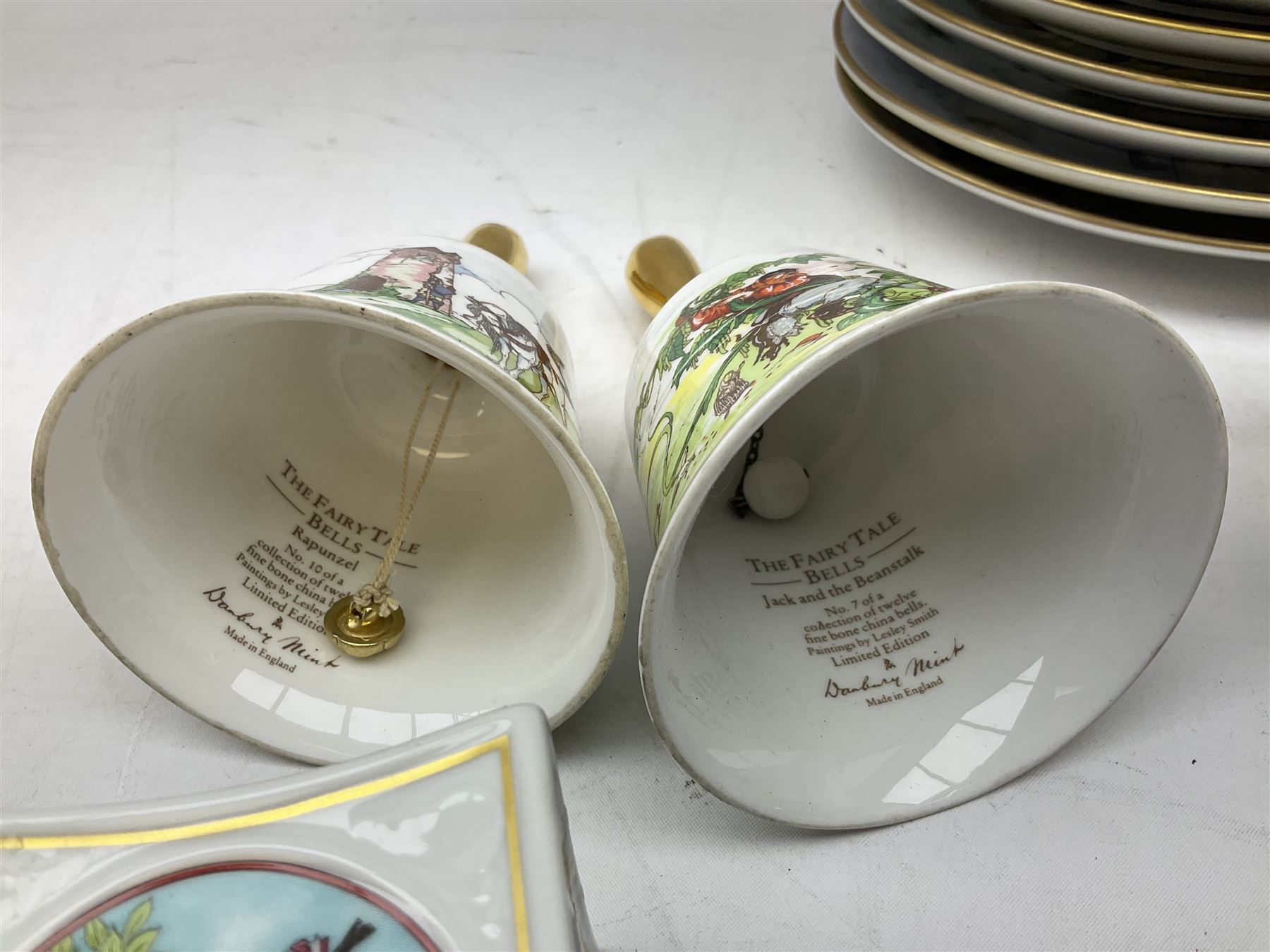 Royal Worcester Flower Fairies oval collectors plates, Goebel mustard pot, two Danbury Mint Fairy Tale bells, and pair of Hutschenreuther candlesticks decorated with scenes of Puss in Boots