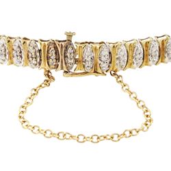 9ct gold diamond chip bracelet, forty-six white gold navette shaped links, each set with three single cut diamonds and with yellow gold surround, Birmingham import mark