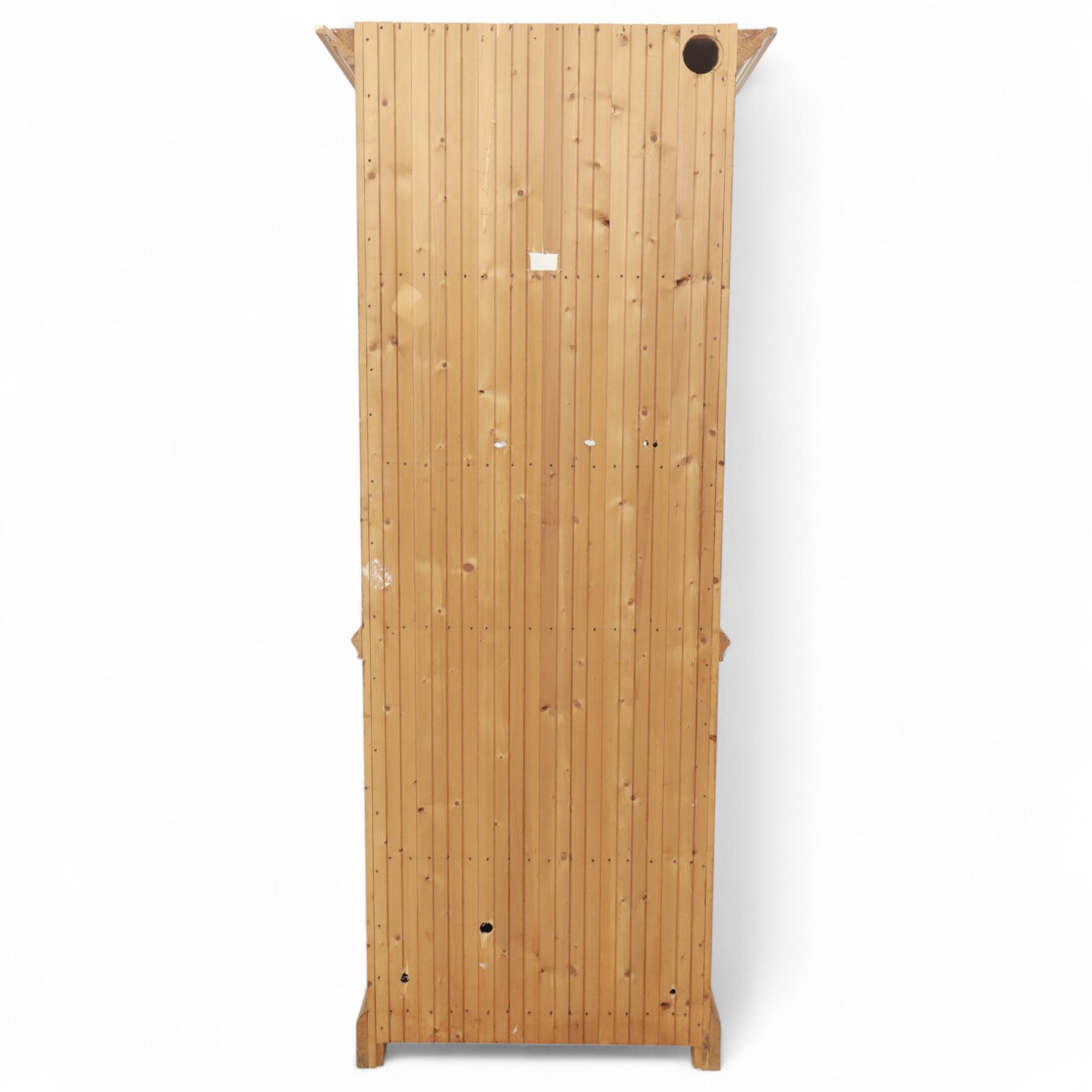 Contemporary stripped pine bookcase cabinet, the upper section with arched frieze and open shelving flanked by barley twist columns, over a single door cupboard base with matching twist supports and fielded panel door