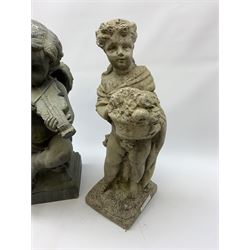 Two composite stone effect garden sculptures, the first example modelled as a cherub with violin, H50cm, the second as a cloaked figure carrying a basket of flowers, H49cm. 