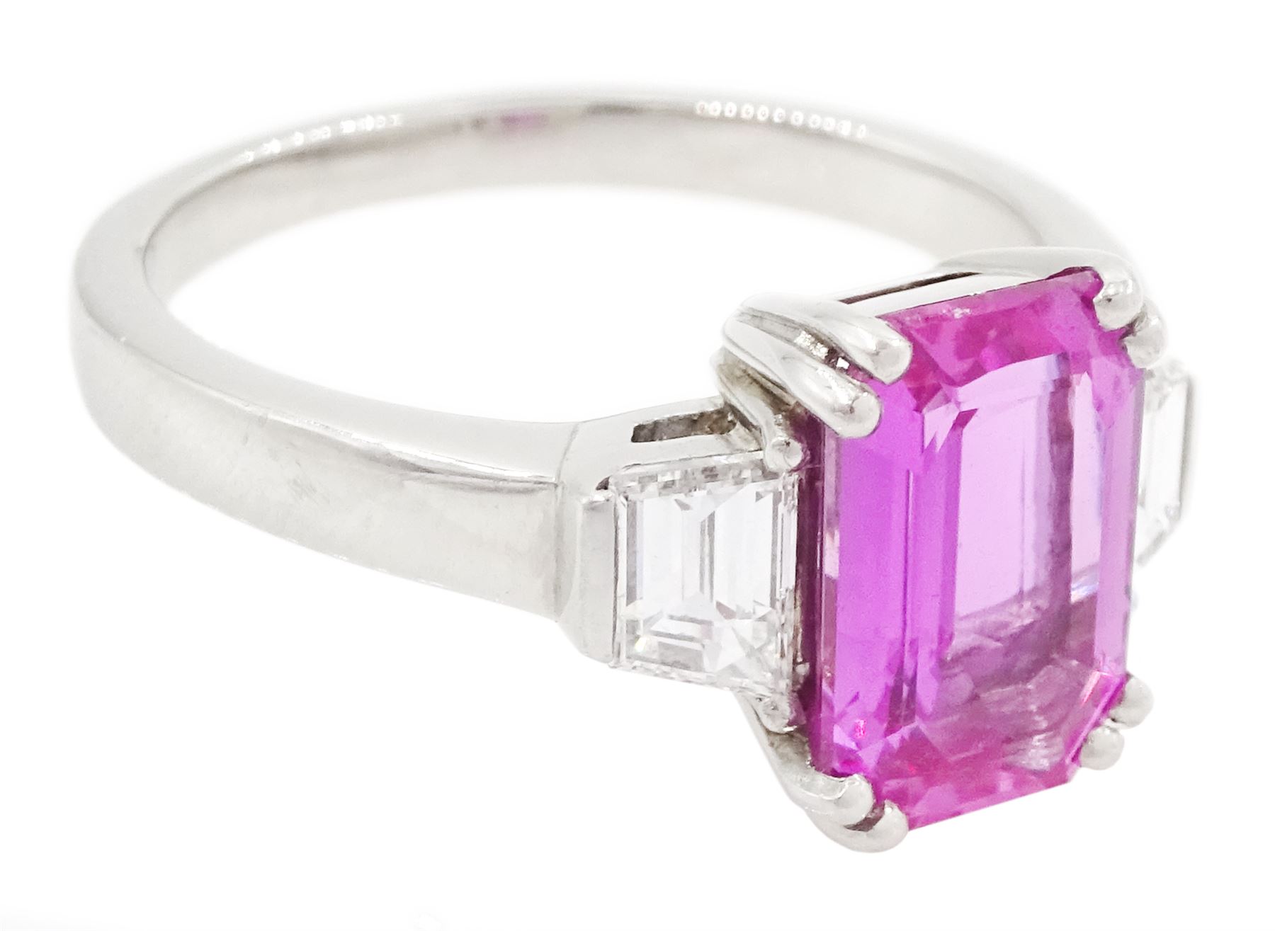 Platinum unheated pink sapphire and diamond three stone ring, emerald cut unheated sapphire of approx 3.16 carat, with a single trapeze cut diamond set either side, London 2014, total diamond weight approx 0.71 carat, with Alan Poultney Gems report, the sapphire with The Gem & Pearl Laboratory report