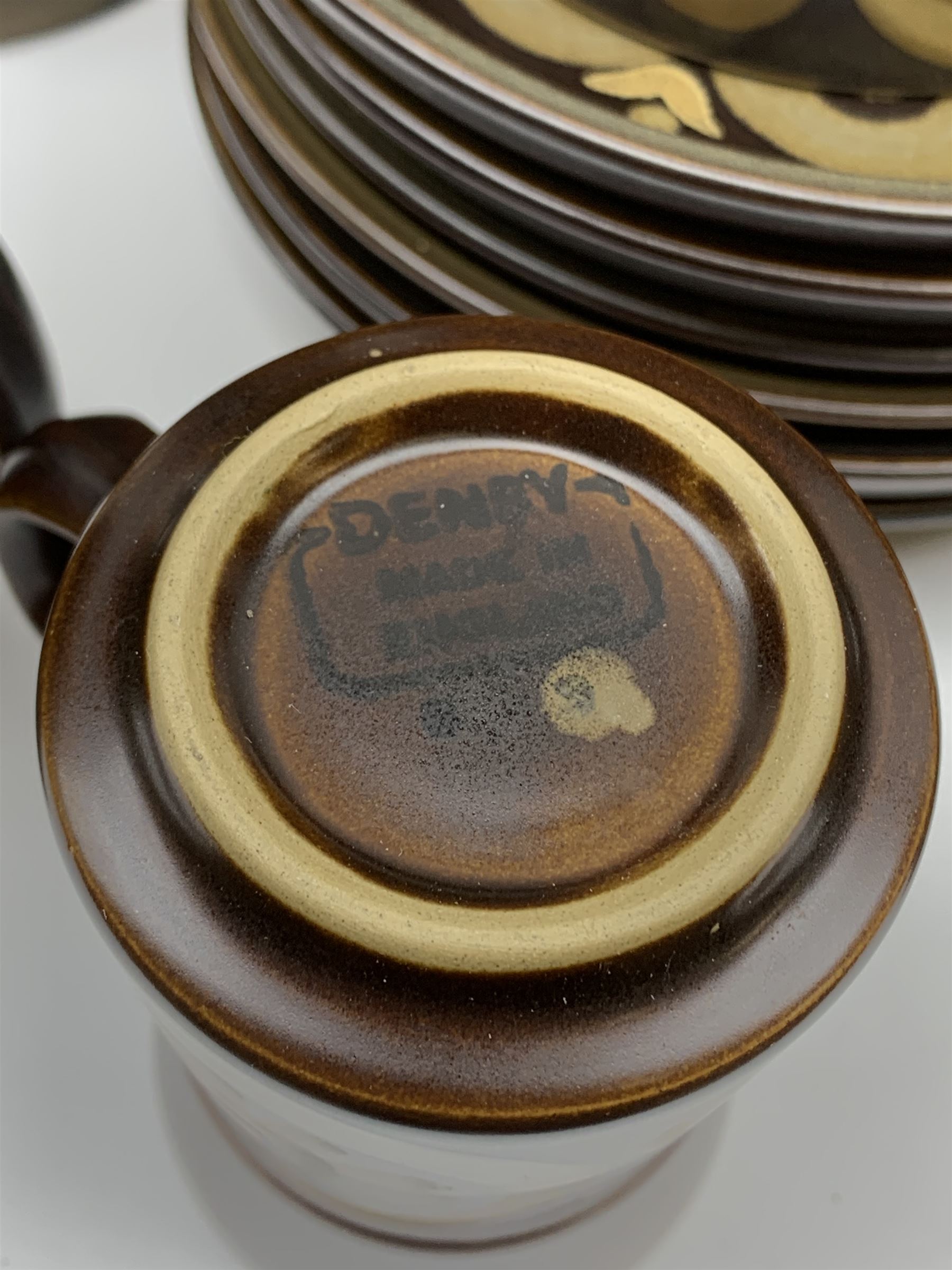 Denby Arabesque patter tea and dinner wares, comprising six dinner plates, twelve side plates, six twin handled bowls and covers, two tureen and covers, four oval serving platters, coffee pot, water jug, milk jug, cream jug, sucrier and cover, and eight coffee cans. 