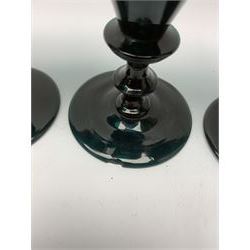 19th century green glass ships decanter with flat topped stopper, H21.5cm, together with a set of four 19th century green glass wine glasses, the funnel bowls upon bladed knopped stems and circular feet, H13cm