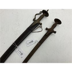 Late 19th/early 20th century Indian Tulwar sword with 81cm plain curving steel blade and iron hilt with extended langets, knucklebow and spiked pommel; in leather covered scabbard L100cm overall; and another Tulwar lacking scabbard in almost relic condition (2)