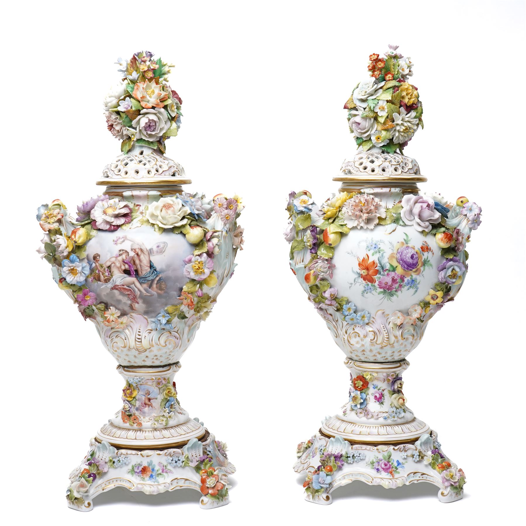 Pair of 19th century Potschappel porcelain two handled vases with covers and stands, painted with scenes of classical figures including Dionysus and Ariadne and with profusely applied flower heads on a scrolling field with gilt highlights H49cm (2)