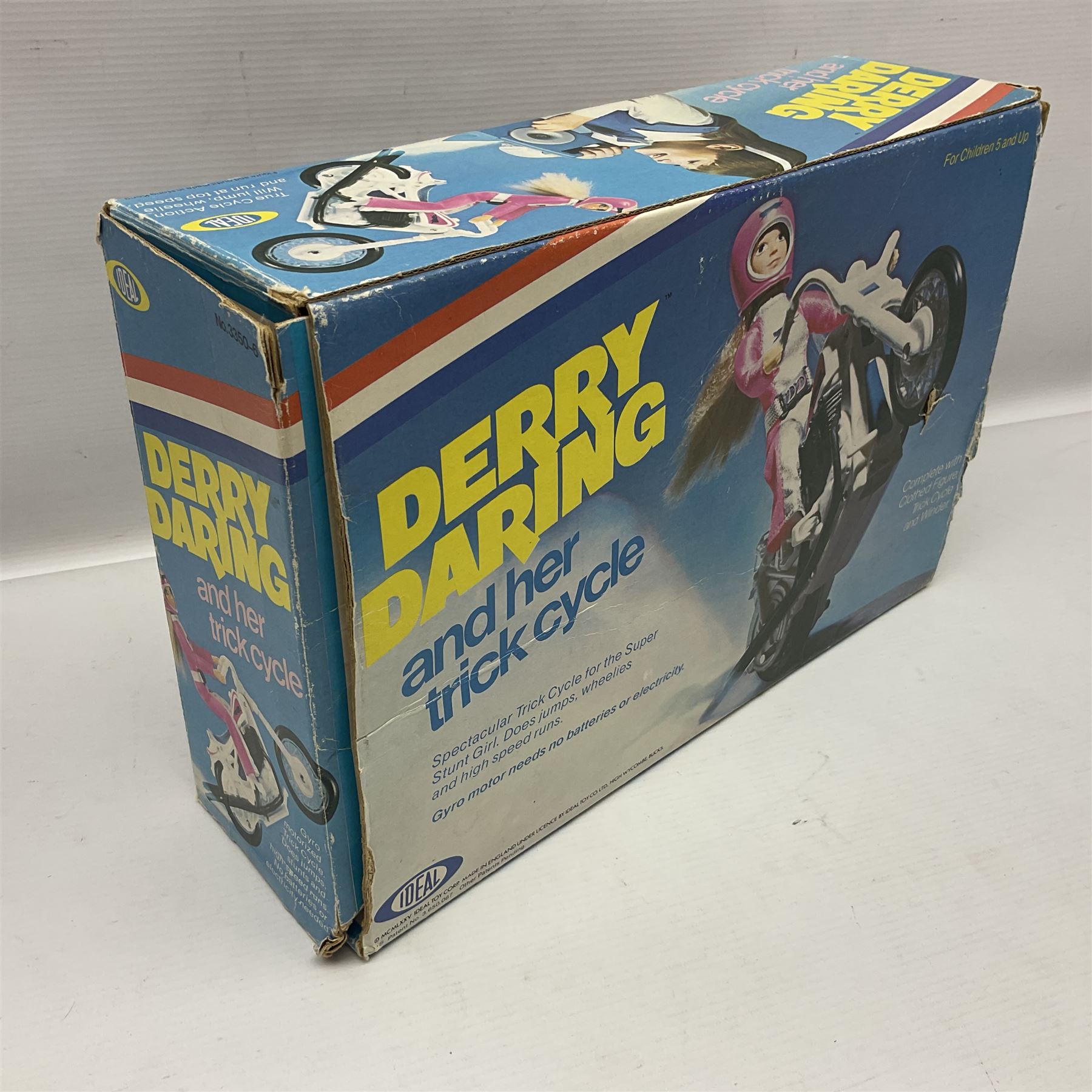 Ideal Derry Daring and Her Trick Cycle, with clothed figure on trick cycle and winder; in original illustrated box dated 1975
