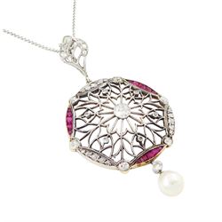 Early 20th century platinum and 18ct yellow gold ruby and diamond circular pendant, single old cut diamond of approx 0.25 carat, within a milgrain pierced fancy foliate surround, set with single cut diamonds, to a navette shaped border set with alternate calibre cut rubies and rose cut diamonds, each spaced by a single old cut diamond, suspending a pearl and diamond drop, on a later 18ct white gold wheat link chain necklace, hallmarked