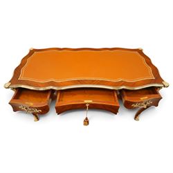 Baggio Anciens Meubles - Italian Louis XV style kingwood and gilt metal mounted bureau plat or writing desk, the shaped rectangular top with inset leather writing surface with gilt metal edge, above three shaped frieze drawers with gilt metal handles, raised on cabriole supports with gilt cartouche mounts to the knees and scroll feet