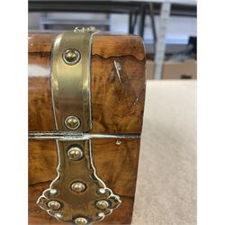19th century walnut and brass bound games compendium box, painted to enhance the grain, of rectangular form, the hinged opening cover with rounded sides, central brass cartouche with engraved lion crest, and brass riveted straps, opening to reveal a red leather and blue silk lined compartmented interior, with fold-down games board, and lift-out tray containing playing cards, ebony turned dice towers, white and red stained bone draughts, and chess pieces, ivory dice, and ivory and ebony whist markers, and brass bezique board, cribbage board and markers, H15cm W32cm D24cm
This lot has been registered for sale under Section 10 of the APHA Ivory Act