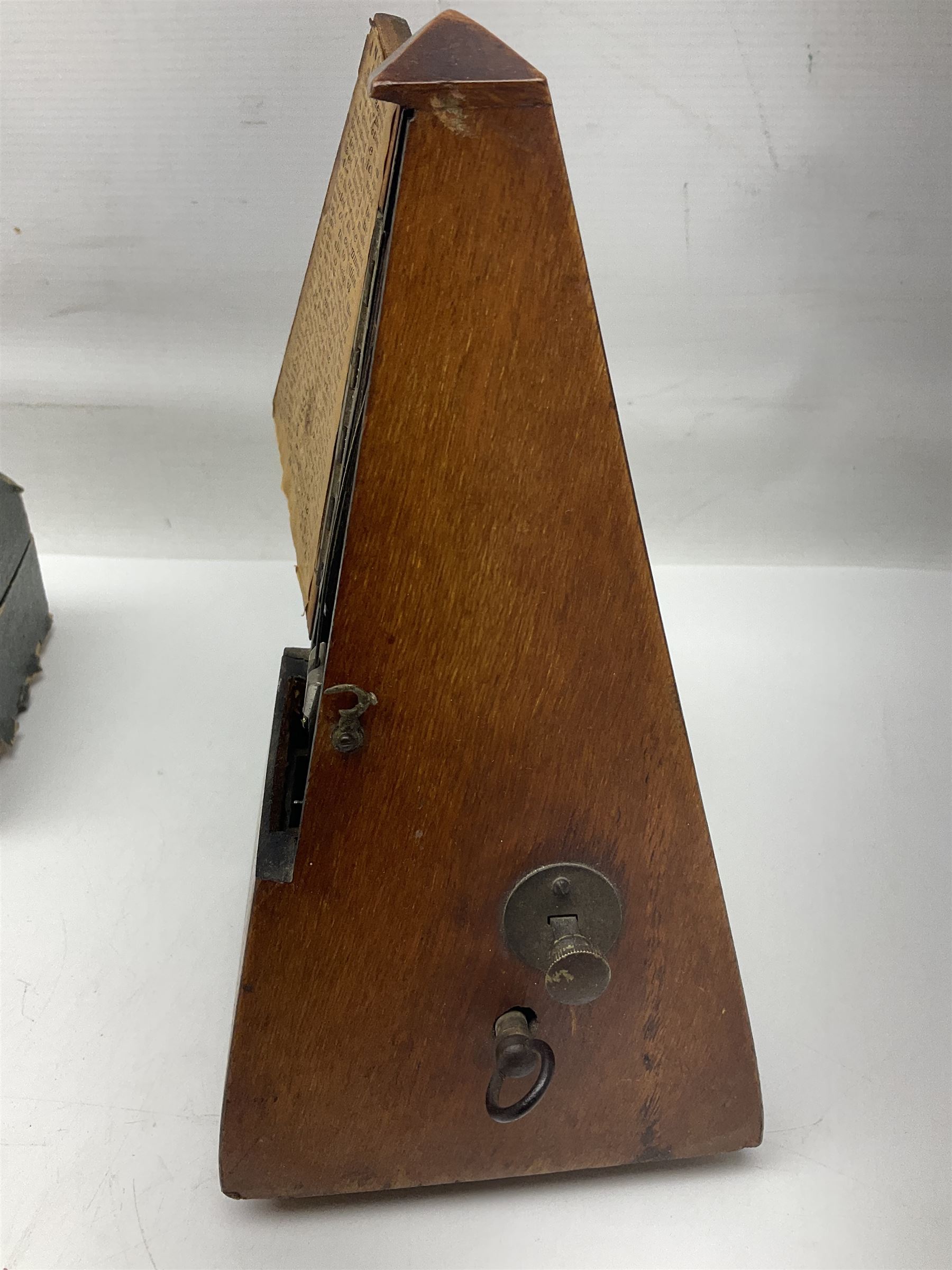 Early 20th century Hawkes and Son simple system hardwood clarinet serial no.1HM257102; cased; and a Swiss Maelzel BS Dulcet metronome of typical pyramid form (2)