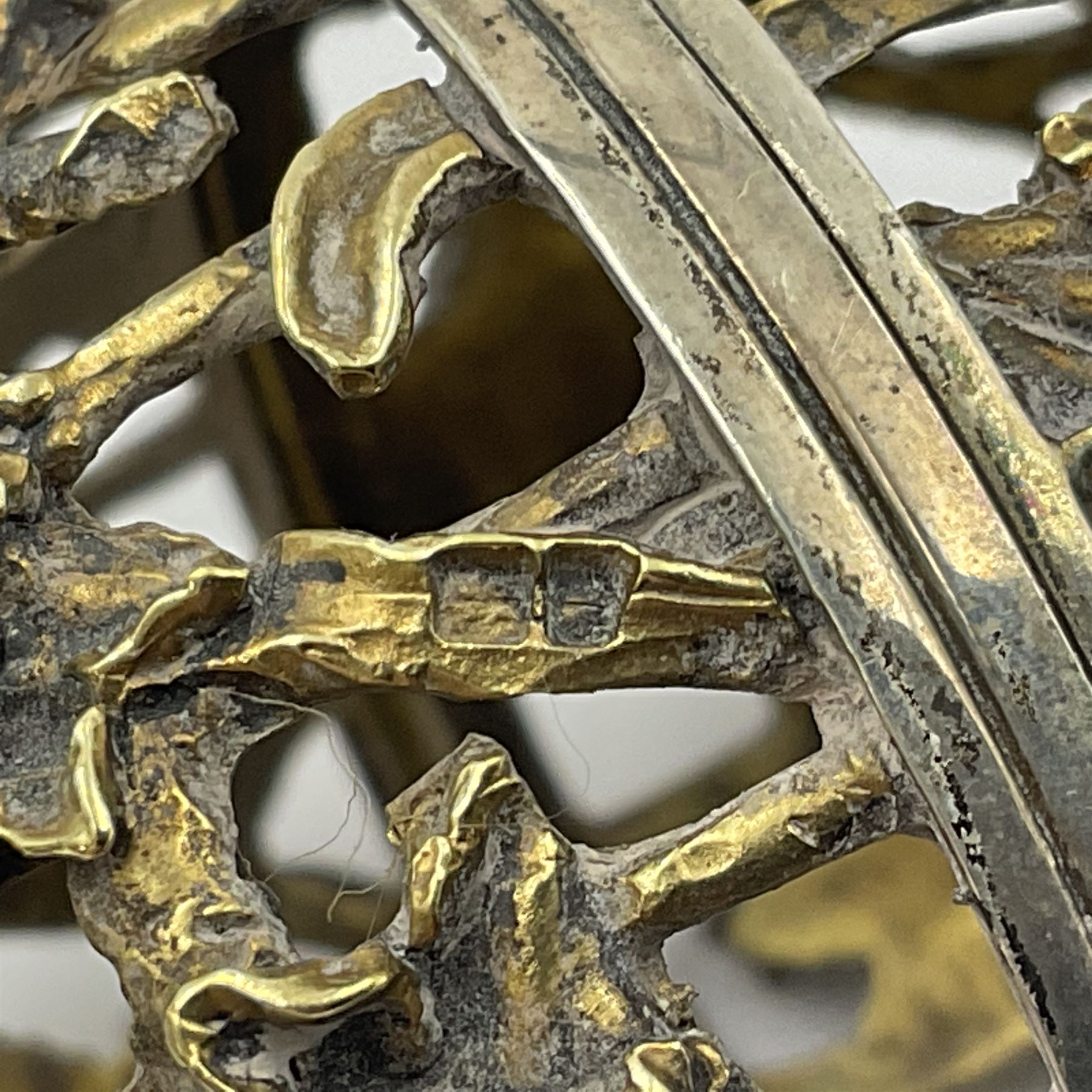 Modern silver limited edition Easter egg, no. 70/500, the gilt openwork body decorated with daffodils and detachable cover with pierced circular panel set with a single faceted blue stone, opening to reveal a gilt interior, upon silver stand with three scrolling pad feet, each hallmarked St James House Company, London 1980, height including stand 8cm