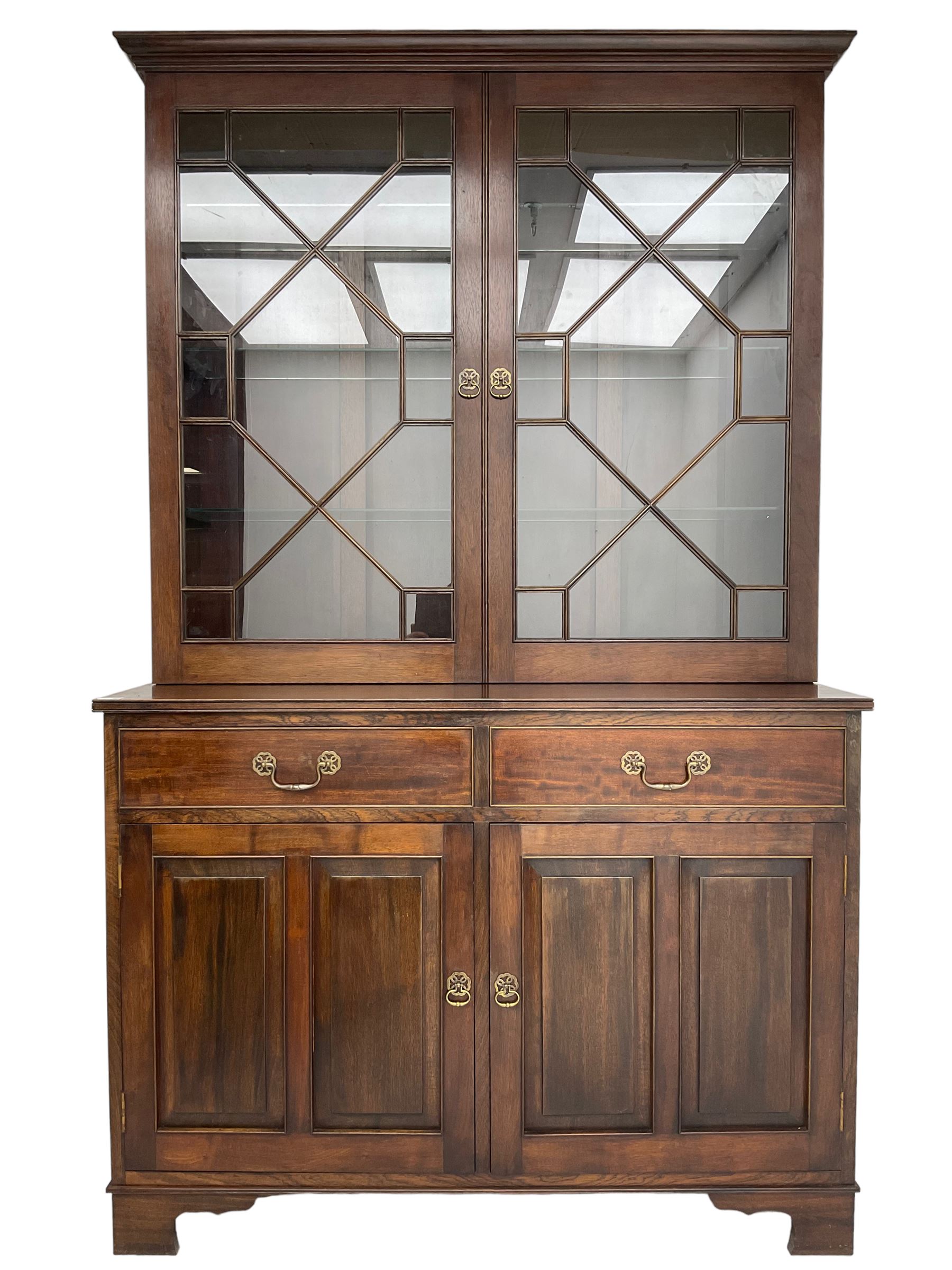 Acorn Industries - Georgian design mahogany bookcase on cupboard, fitted with two astragal glazed doors enclosing three glass shelves, base with two cock-beaded drawers over two panelled cupboards, inlaid with acorn signature, by Alan Grainger, Brandsby