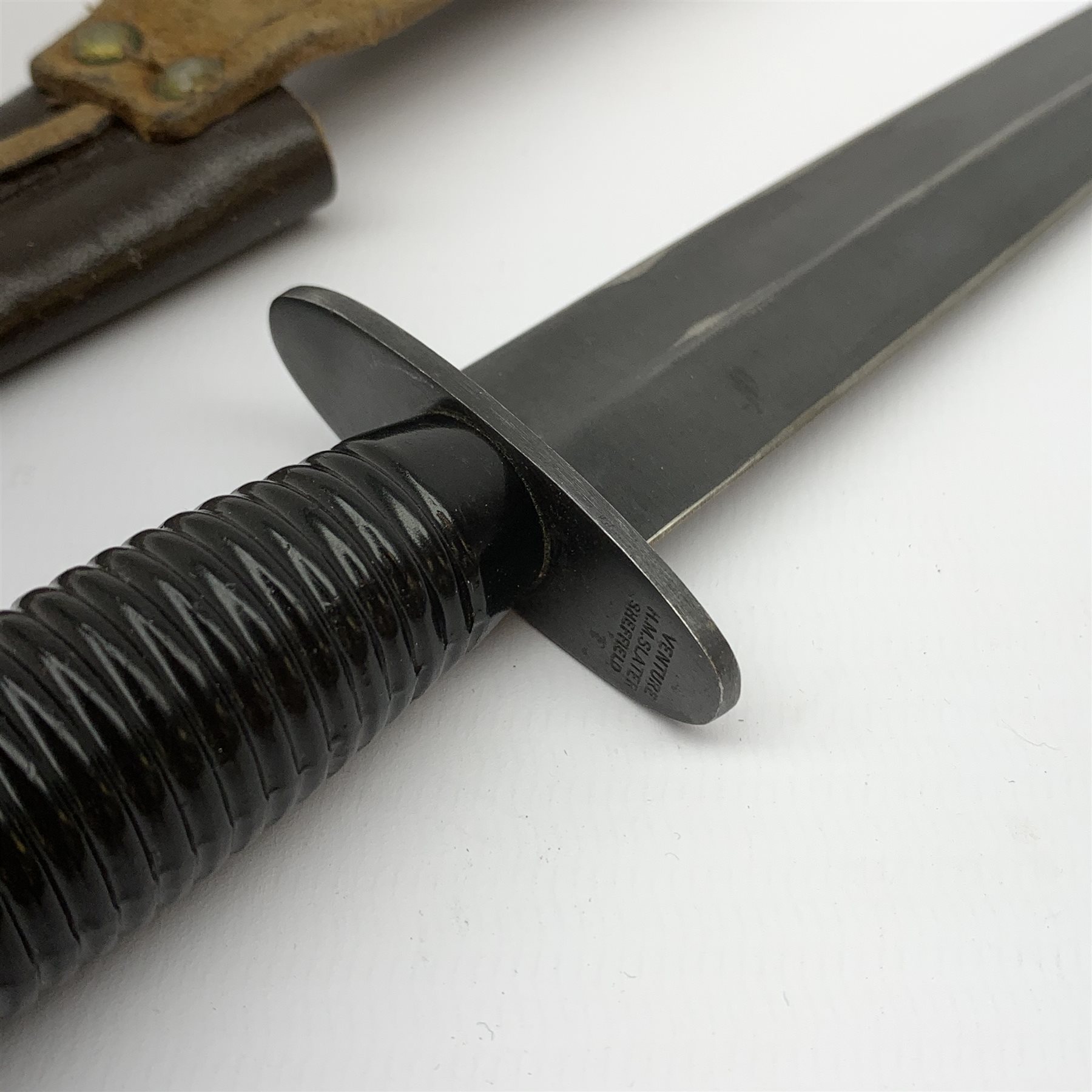 British Fairburn-Sykes style fighting knife, the cross-piece marked Venture H.M. Slater Sheffield L29.5cm, in leather sheath