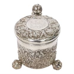 Northern European silver peg tankard, probably late 18th/early 19th century, of cylindrical form, the body repoussé decorated with scrolling and blossoming acanthus, fitted with scroll handle with shield terminal, the hinged cover with conforming repoussé decoration surrounding a central circular panel engraved with monogram beneath initials EASBGD, opening with ball thumbpiece detailed with fruits, raised upon three confirming ball feet mounted with shaped panels also detailed with fruits, bearing indistinct mark beneath, H19cm
