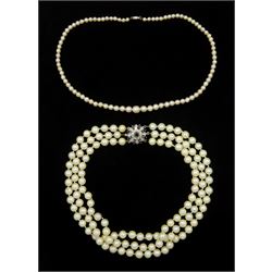 Three strand cultured pearl necklace, with 9ct white gold sapphire diamond chip clasp and a single strand pearl necklace, with white gold clasp, stamped 9ct
