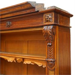 Large early 19th century Country House mahogany breakfront library bookcase, the projecting moulded cornice over a frieze applied with carved flowerhead paterae, the open panelled upper section fitted with adjustable shelves and shaped valances, divided by moulded pilasters with acanthus-carved corbels, the projecting base enclosed by eight panelled cupboard doors with central turned canted pilaster, on plinth base