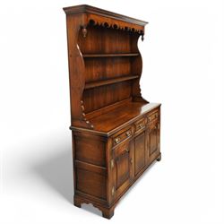 Gostins of Liverpool - Georgian design oak dresser, the two-tier rack with moulded cornice over shaped frieze and end supports, the dresser base with moulded rectangular top over tree drawers and two cupboards, panelled sides, on bracket feet
