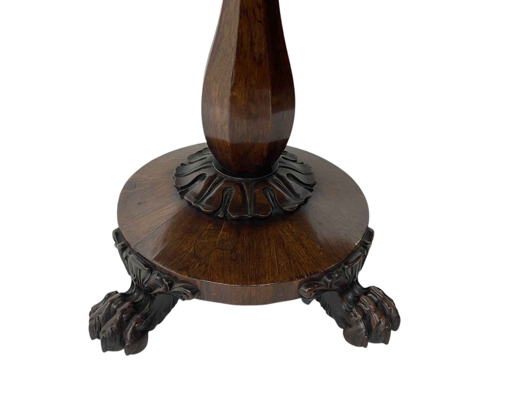Victorian mahogany tea table, rectangular top with rounded corners, folding and swivelling to reveal interior surface, supported on a faceted baluster-shaped column, raised on a circular platform base with carved acanthus details, ending in four lion paw feet