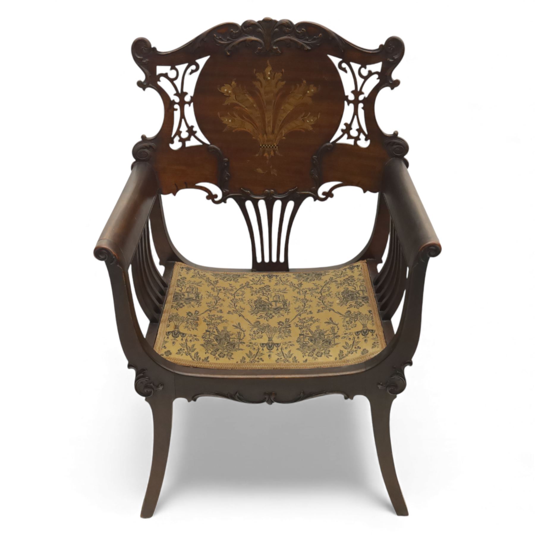 Art Nouveau mahogany open armchair in the manner of Shapland & Petter, the shaped and pierced back with foliate cresting and central panel inlaid with stylised marquetry plume, curved arms over upholstered seat, raised on sabre legs