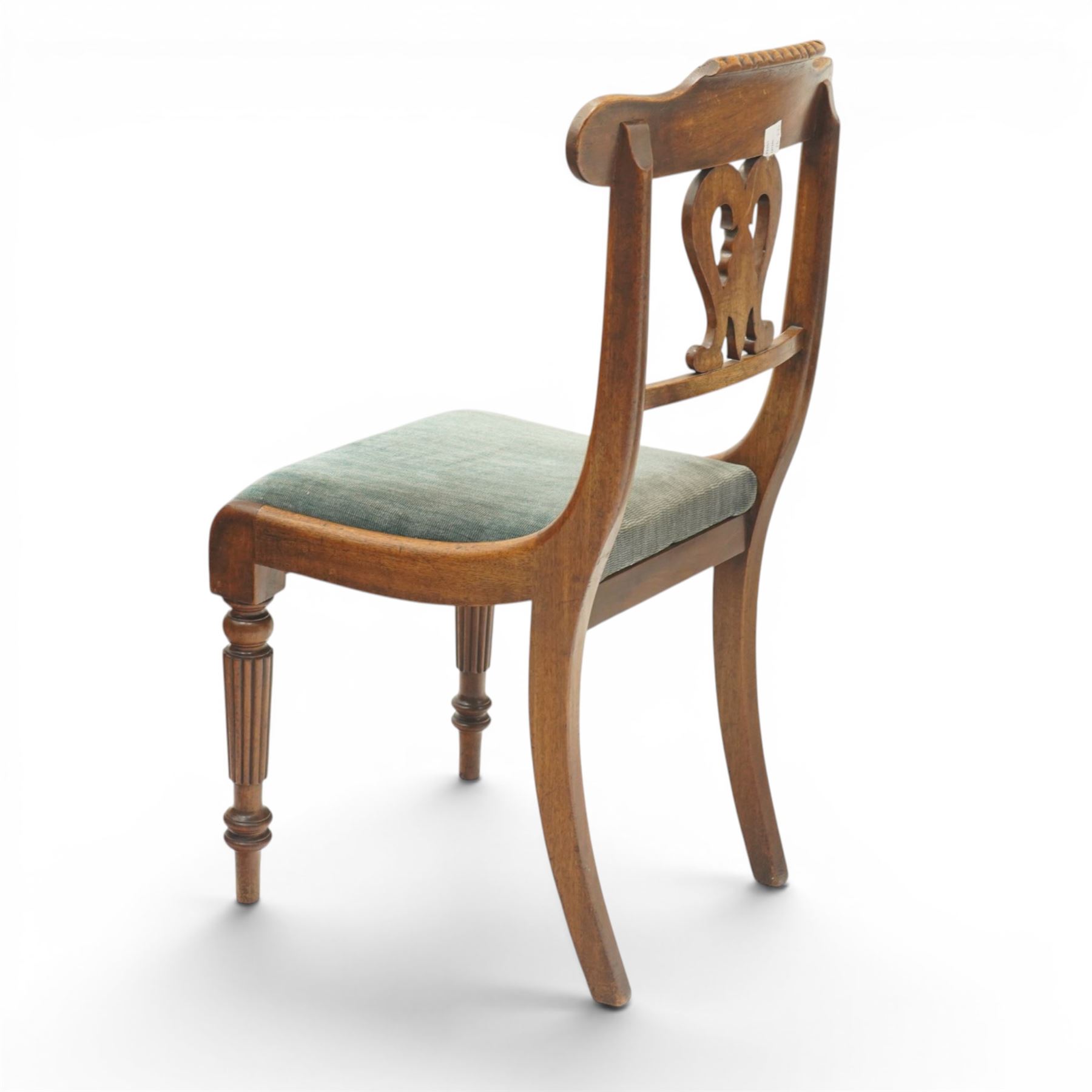 Set of eight (6+2) Regency period mahogany dining chairs, the ornately carved cresting rail of gadrooned and foliate design, over a pierced swan-neck splat with scrolling foliate carving, the carvers with scrolled arm terminals, over teal-upholstered drop-in seats, raised on Gillows-design reeded and tapering front supports, retailed by David Hick Interiors, Jersey